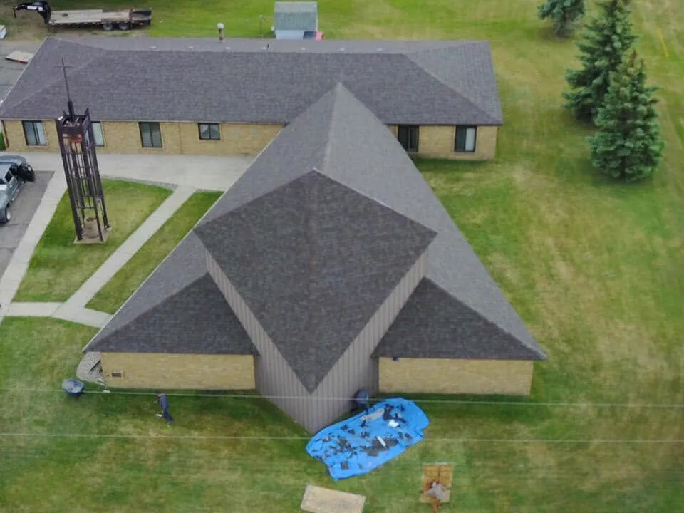 Aerial view of a finished shingle roof on a commercial building