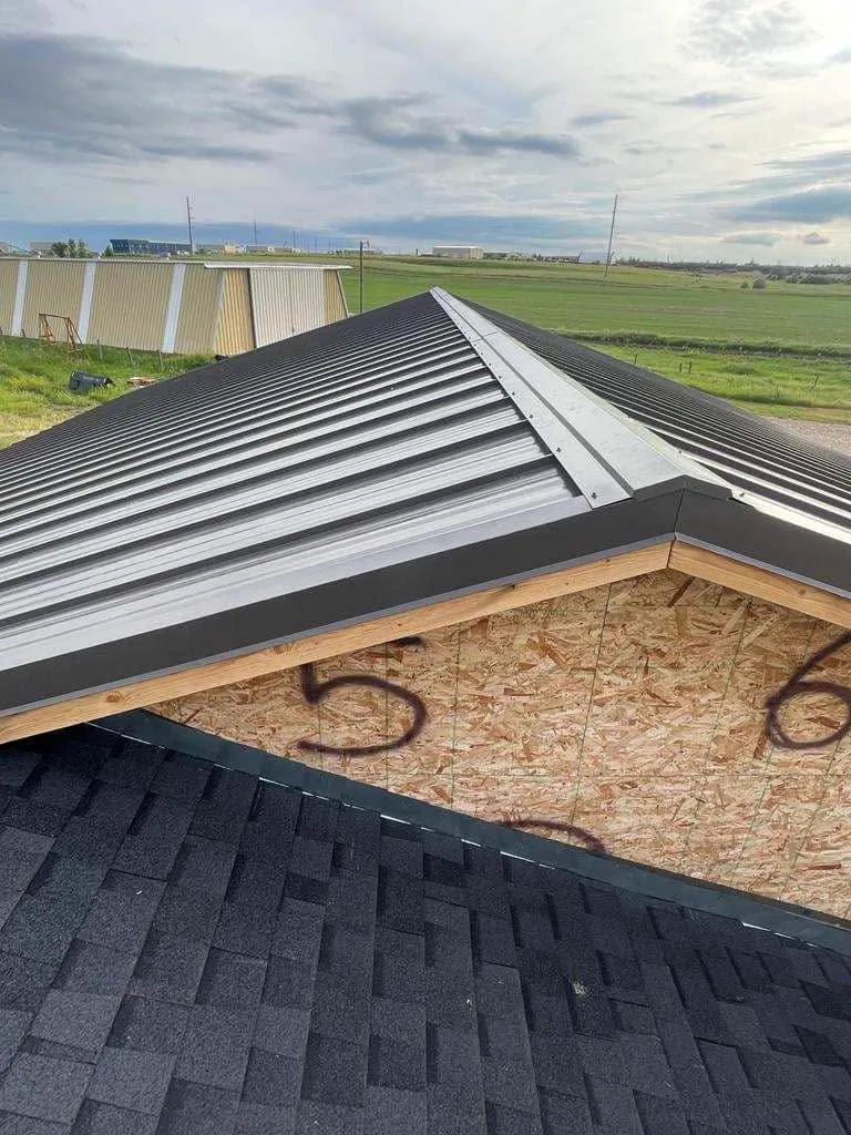A new black standing-seam metal roof installed over fresh decking